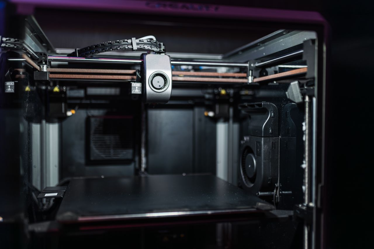 Close-up view of a modern 3D printer interior showcasing advanced technology.